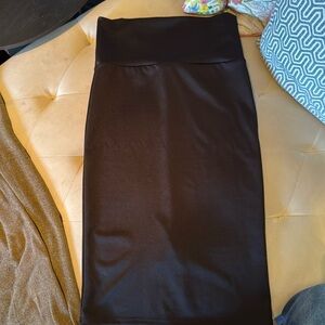 Black sleek body-con pencil  skirt with small slit. Some compression. EUC